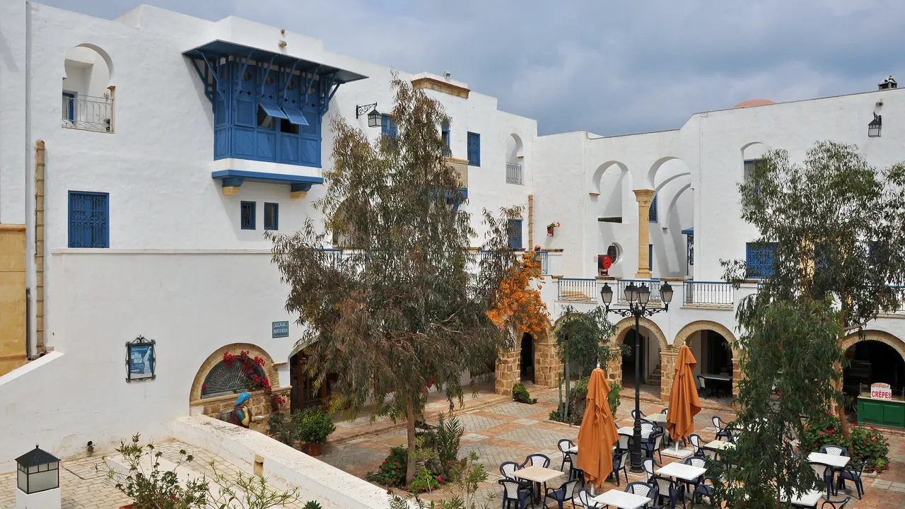 A café courtyard among the white, blue-shuttered houses of the Hammamet medina